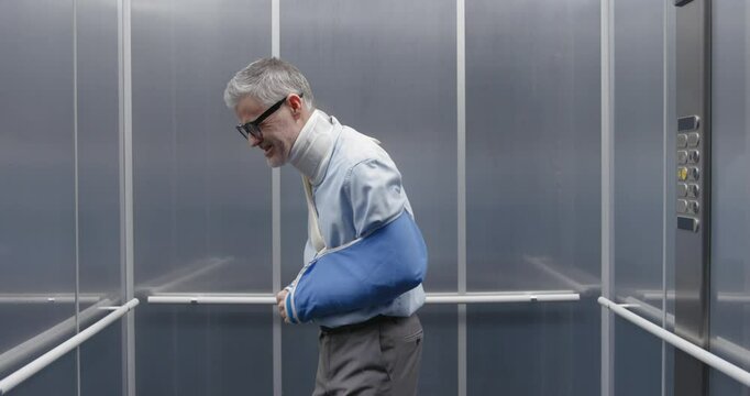 Cheerful man faking an injury and deceiving an insurance company