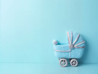 Blue newborn background, minimal style. Baby shower invitation. Baby boy announcement. Fondant baby stroller accessories. Flat lay, minimal style, text space.
