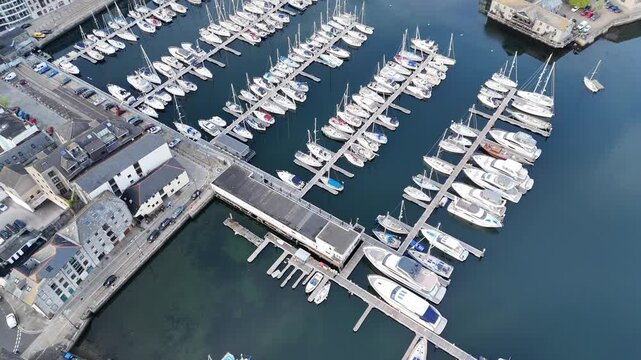 Aerial view over Sutton Wharf with anchored boats and yachts surrounded by urban architectures