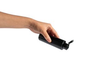 Black cosmetic flip top bottle in hand isolated on transparent background.