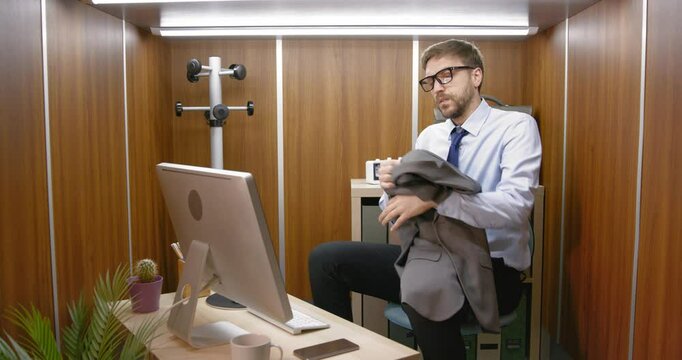 Frustrated businessman starting his workday in a small office