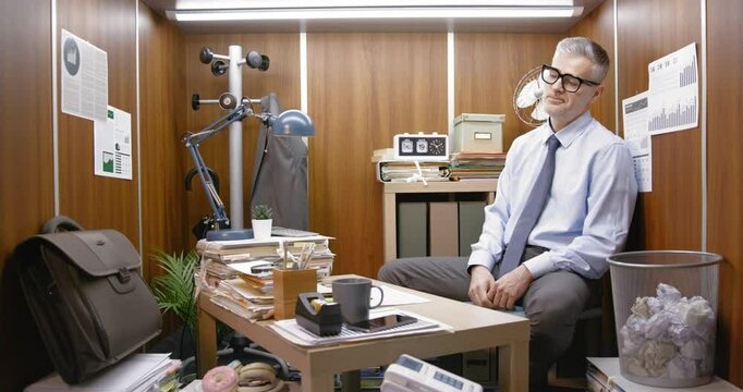 Bored inefficient employee wasting time in his small office