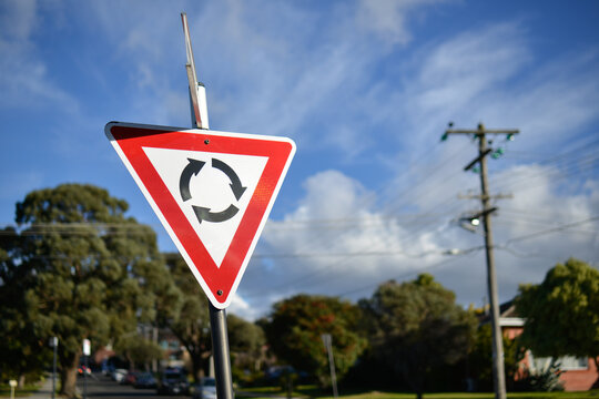 A give way at the roundabout street sign in the sun