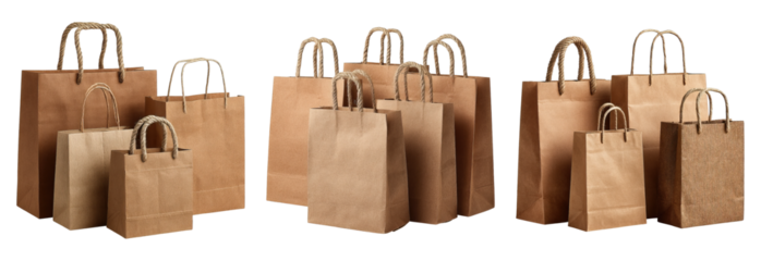 Brown paper shopping bags with rope handles in various sizes isolated on black