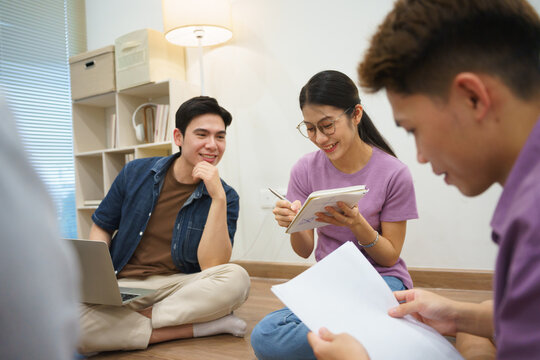 Young adults engaged in collaborative study session in cozy indoor environment during evening hours