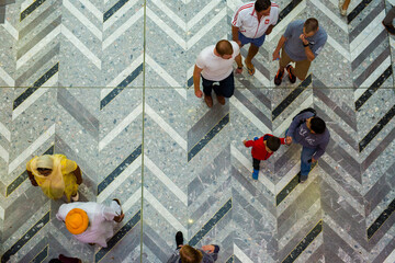 People seen from above walking in a shopping mall