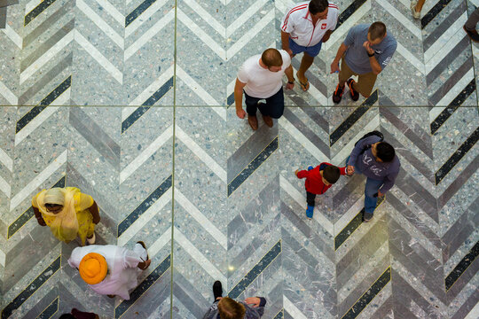 People seen from above walking in a shopping mall