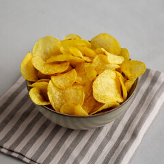 Homemade Kettle Cooked Potato Chips with Salt in a Bowl, side view.