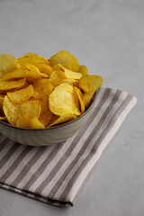 Homemade Kettle Cooked Potato Chips with Salt in a Bowl, side view.