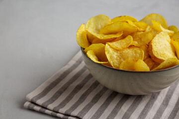Homemade Kettle Cooked Potato Chips with Salt in a Bowl, side view.