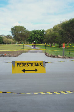 Safety black and yellow tape with pedestrians sign at the park