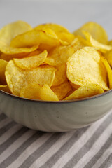 Homemade Kettle Cooked Potato Chips with Salt in a Bowl, side view.
