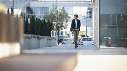 Businessman on e scooter in the city