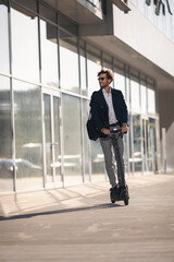 Businessman on e scooter in the city