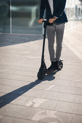 Businessman on e scooter in the city