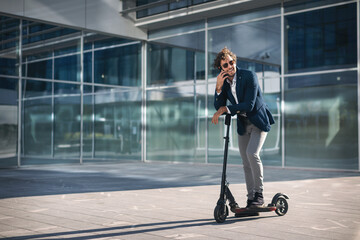 Businessman on e scooter in the city