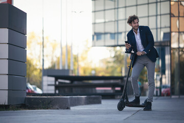 Businessman on e scooter in the city
