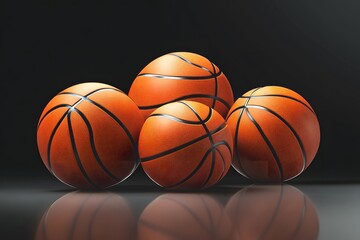 Obraz premium Arrangement of basketballs in varying sizes reflecting on a dark glossy surface