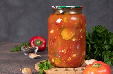 Cucumber and sweet pepper salad in tomato sauce in a glass jar