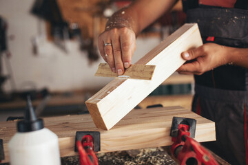 Young carpenter glueing wood