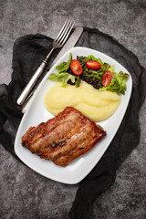 Braised ribs with potato puree and salad