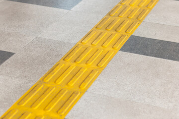 Pedestrian walkway with yellow guiding block brick