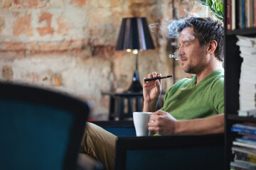Young man using electronic cigarette