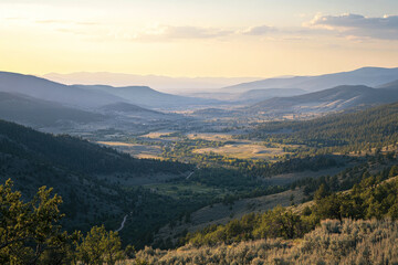 Obraz premium Aerial view of a mountain valley with trees and fields at sunset or sunrise