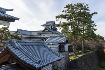 Traditional Japanese castle architecture at Kanazawa Castle with layered rooftops, fortified stone...