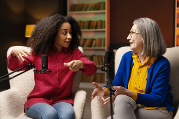 Two women recording a podcast in a studio
