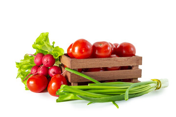 Tomatoes, radishes, green onions and lettuce in a wooden box. Isolated on white background.