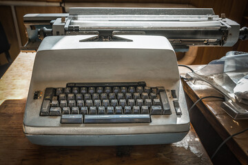 Old typewriter on an old wooden office desk