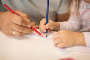 Father and his cute little girl crafting airplane from papper