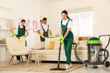 Professional cleaning service team working in room