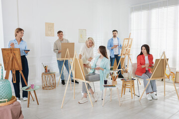 Artist and her students having painting class in studio