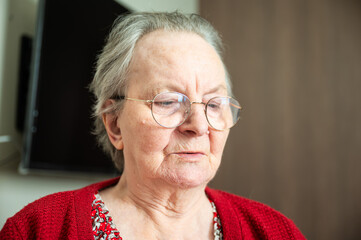 Expressive portrait of an 86 yo grandmother sitting in a wheelchair home in Tienen, Flemish...