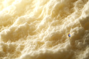 Obraz premium Close-up view of textured, creamy, light-yellow substance.