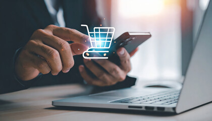 Fototapeta na wymiar Businessman hand using smartphone and laptop with digital shopping cart icon, online shopping, e commerce, technology, internet, digital marketing, and modern business concept