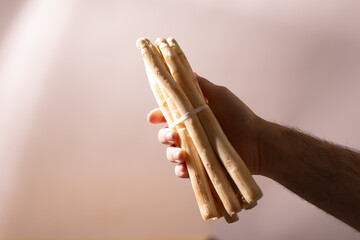 Close-up of a hand holding a bunch of fresh white asparagus. Perfect for recipes and healthy eating...