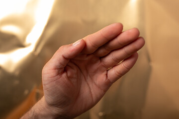 High-quality stock photo of a male hand, showcasing texture and detail against a warm, golden...