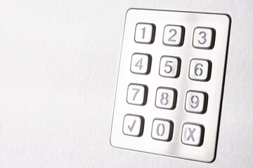 Tilted metallic numeric keypad panel