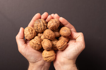 Close-up of hands holding walnuts.  Healthy snack,  nutrition.
