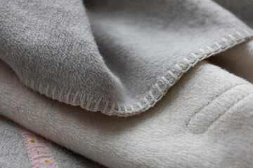 Luxurious fleece blanket in grey and cream. Perfect for snuggling on the couch.