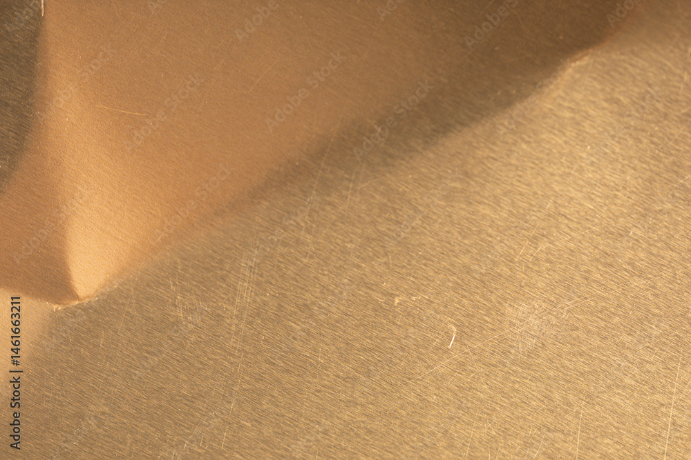 Poster high-resolution image of brushed gold metal texture. perfect for backgrounds and design projects.