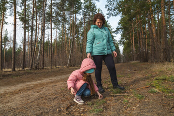 Grandmother and granddaughter walking in the forest