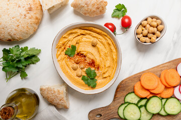 Fresh homemade hummus dipping sauce with vegetables and pita bread. vegan food healthy eating