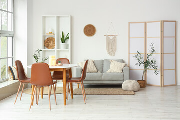Interior of stylish living room with comfortable sofa and dining table