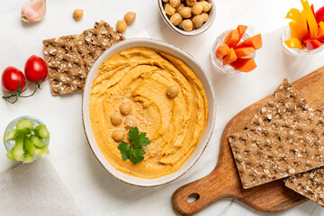 Fresh homemade hummus  with vegetables  sticks and chickpea and multigrain crackers. vegan food healthy eating
