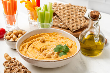 Fresh homemade hummus  with vegetables  sticks and chickpea and multigrain crackers. vegan food healthy eating