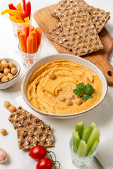 Fresh homemade hummus  with vegetables  sticks and chickpea and multigrain crackers. vegan food healthy eating
